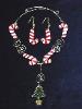 Candy Canes Necklace & Earrings Set-This porcelain handmade necklace is painted in glossy red and white for the candy cones and green and gold enamel details for the Christmas tree.  Also some foil effects are applied. Austrian Crystals, glass  beads and gold plated wire is used for final details. Earrings, are one set of two Candy Cones design