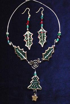  This porcelain handmade necklace is painted in glossy  green and gold enamel details.  Also,  some foil effects are applied. Austrian Crystals, glass beads and gold plated beads are used for final touches. Gold plated wire is used for final details. Earrings, are one set of two Leaves design.