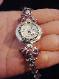 Handcrafted Jewelry Pink & Purple Watch- Handcrafted with Drop Glass Purple & Pink beads. Embellished with Silver plated  findings and details. Stretch cord is used for watch band. Round silver and gold details watch face. White Opalescent Geneva sphere. Quartz function and mechanical system. Stainless Steel back and is water resistant. Beautiful and Elegant! 