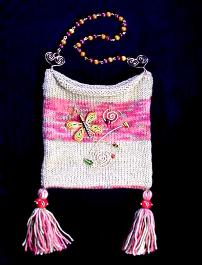 Hand-knitted with silk-wool. Decorated with a handmade Fimo butterfly, glass beads and copper wire. The butterfly is embellished with Austrian Crystals. Purse hanger is also handmade with copper and wooden beads. Unique design!  