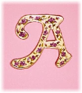 This porcelain handmade pin is painted in glossy mother of pearl ivory w/purple hand painted Victorian flowers. Gold enamel is used for final details. Very Elegant and Lady-like!