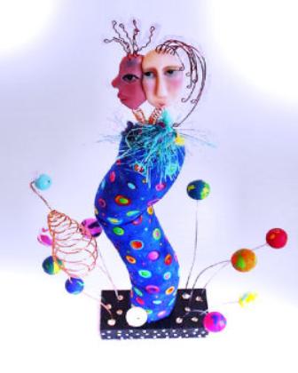 Living in Harmony Figurine - Supporting harmony between races, people, the world and the universe! Handmade with copper, nickel, fabric, fibers, polymer clay, pastel chalks, wood, and paints are the materials used. Figurine is posing on a wood base. Some fabric colors may vary depending on availability.