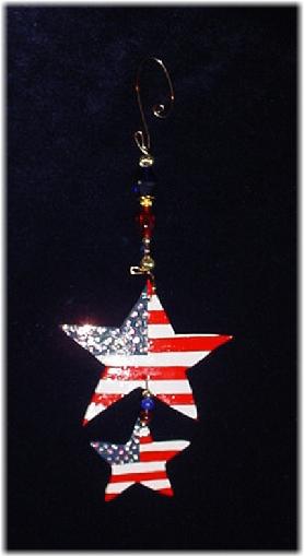 This porcelain handmade ornament is painted in glossy patriotic colors. Also some foil effects are applied. Austrian crystals, glass beads and wire are used for final and hanging details.