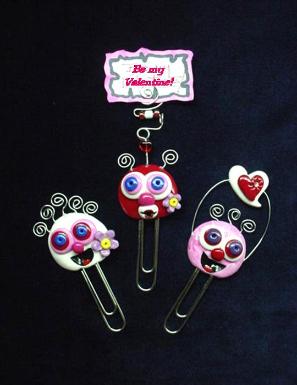 'Valentine's Paper Clips-Handmade with glazed Fimo. Silver wire, glass beads and large paper clips. Functional, colorful, funny and durable. Make everyone laugh with these funny Valentine's Pimpollo Faces! Some are also note holders.