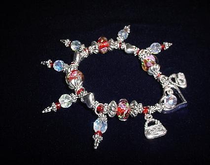 Handcrafted Jewelry Red & White Crystal & Glass Beads Bracelet - Handcrafted with Red and White Glass beads. Transparent Lampwork white and pink  roses flower glass beads are used for a floral and romantic look. Austrian Swarovski Crystals AB are used to embellish the bracelet. Silver plated  beads, charms and findings are used for final details. Stretch cord is used for flexibility  Beautiful and Elegant!