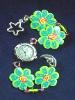 Fimo Green Flower Watch-  Handmade with glazed Fimo. Silver plated  wire, findings and clasps are used for final details. Glass beads are used to embellish the Fimo Green Flowers.